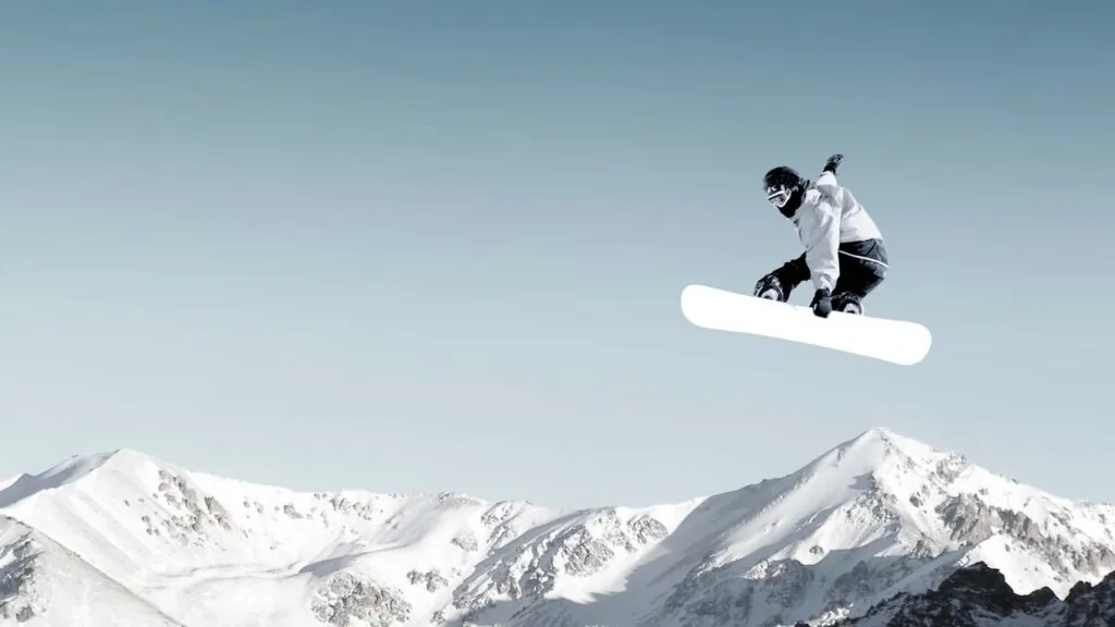 A snowboarder making a high jump in clear, blue sky; Getty Images