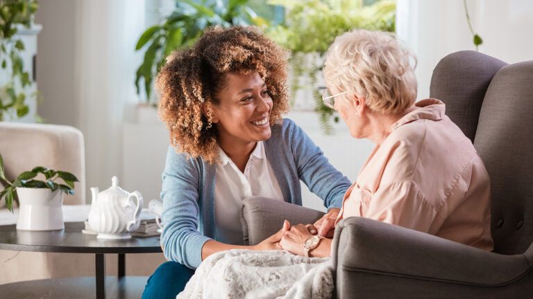 Caregiver smiling at senior woman