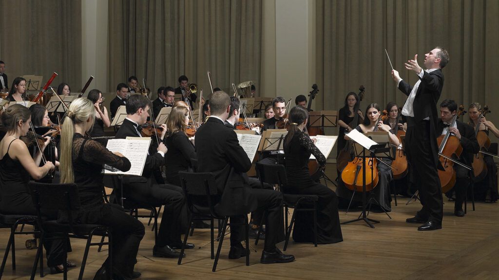 A conductor leads an orchestra