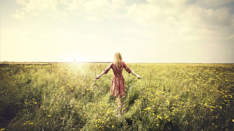 A woman in a sun-drenched field