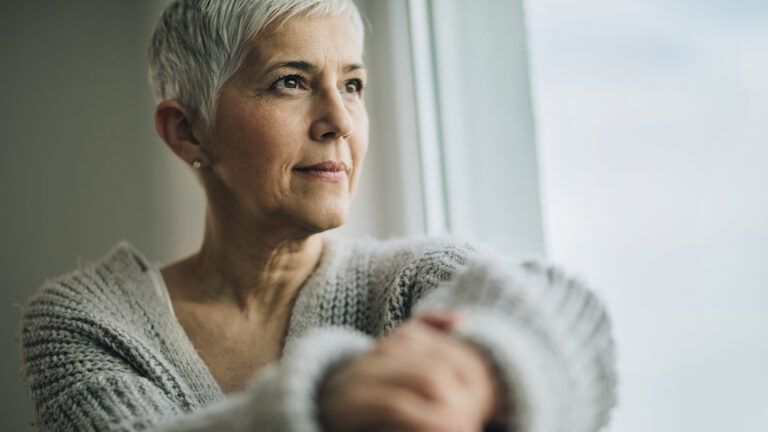 Serene woman looking out of a window