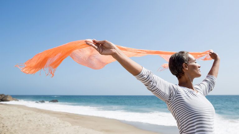 A woman lets her shawl fly in the breeze