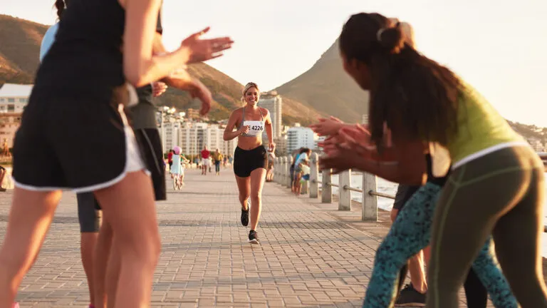 Spectators cheering on a marathon runner