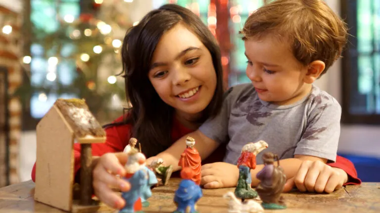 Children setting up nativity scene