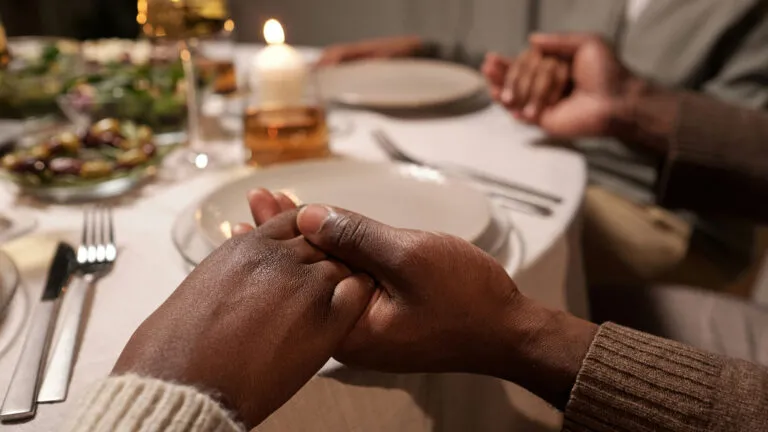 Hands held together in prayer before eating.