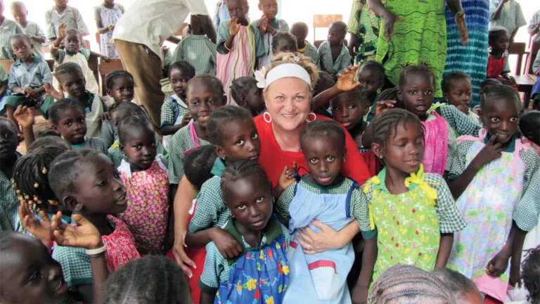 Rachel O'Neill with girls who received dresses from her organization; photo courtesy Rachel O'Neill