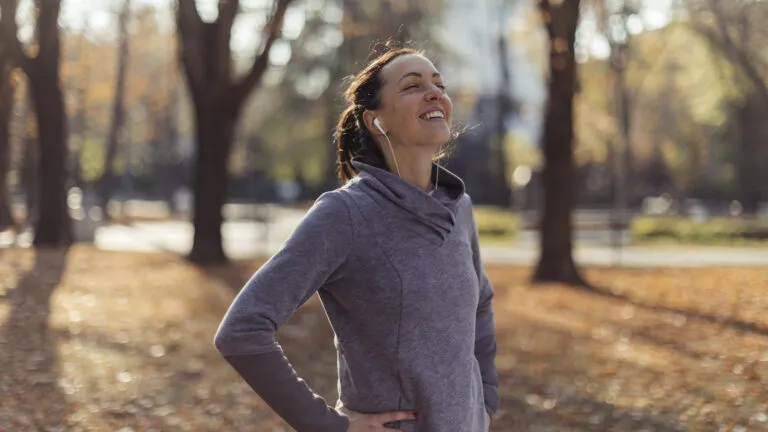 Woman taking a deep breathe outside for her spiritual balance