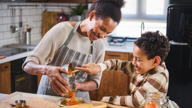 Mother and son baking a pie.