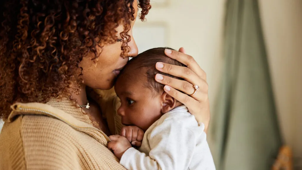 A mother cradling her newborn.