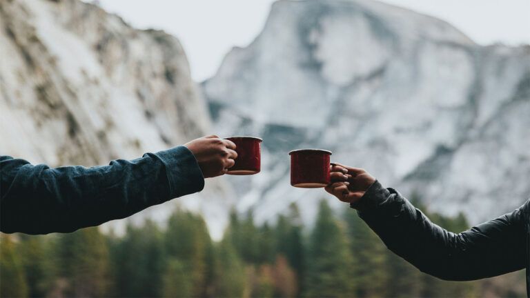 Two people holding red mugs.