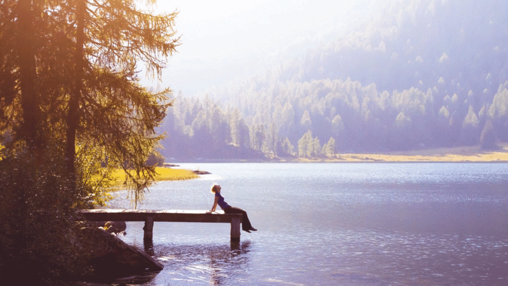 Royalty-free Image: A man relaxes on a lakeside pier; Shutterstock